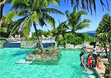 Family playing in the beautiful pool at Sapphire Beach Resort.