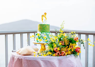 Wedding cake adorned with crystal seahorse.