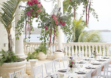 Gorgeous hanging flowers over this beautiful decorated table.