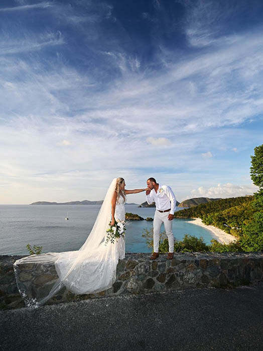 Wedding couple in front of colorful mural in St. Thomas US Virgin Islands.
