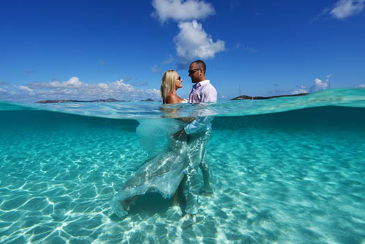 Wedding couple in front of colorful mural in St. Thomas US Virgin Islands.