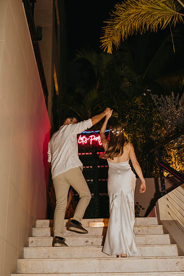 Happily married couple in front of a colorful mural in St. Thomas.