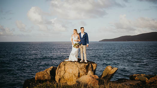 Wedding couple in front of colorful mural in St. Thomas US Virgin Islands.