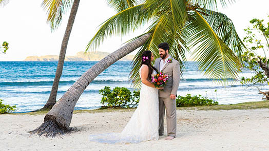 Wedding couple in front of colorful mural in St. Thomas US Virgin Islands.